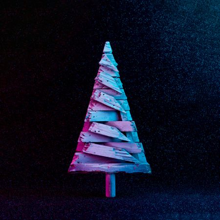 Christmas tree in vivid neon colors on dark  background