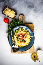 Top view of pasta served with cheese on counter with copy space