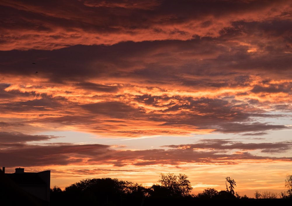Orange cloudy sky at sunset over France
