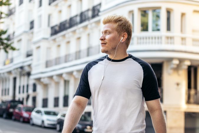 Young Latino man with albinism walking in the Madrid streets