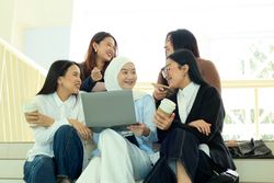 Five University Student Chatting and Discussing Book Sitting at School Campus Stair