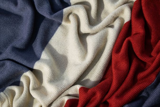 Triple color grey milk and red on knitted fabric wavy crumpled background texture.