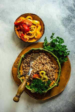 Top view of bowl buckwheat with tomatoes and mini peppers