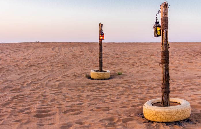 Poles with lanterns in desert