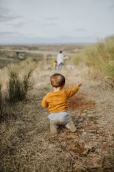 Rear shot of baby boy on a walking trail on an overcast day