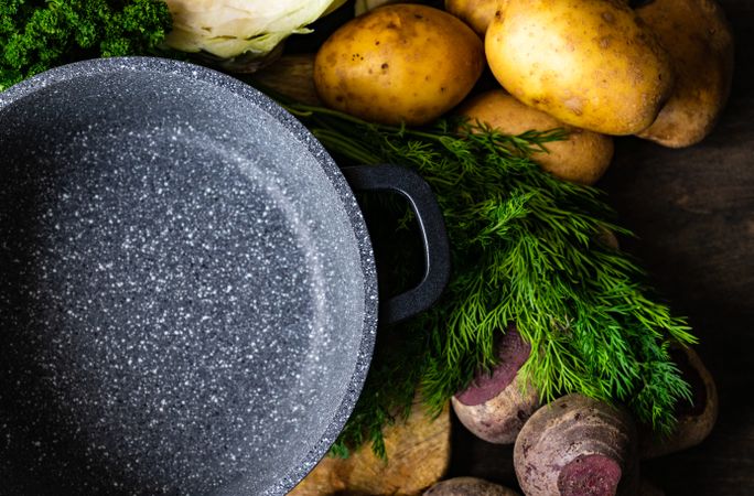Top view of fresh ingredients for Ukrainian soup surrounding pan