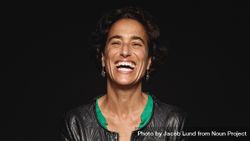 Close up of a laughing woman with short hair isolated on dark background 0vzPL0