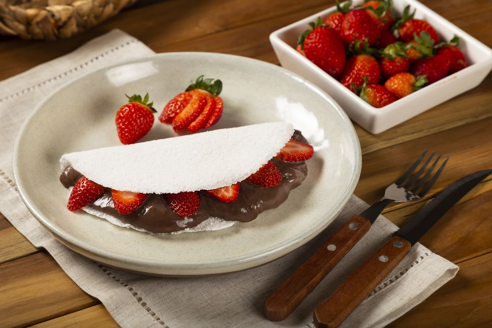 Sweet tapioca stuffed with chocolate and strawberry. Brazilian tapioca.