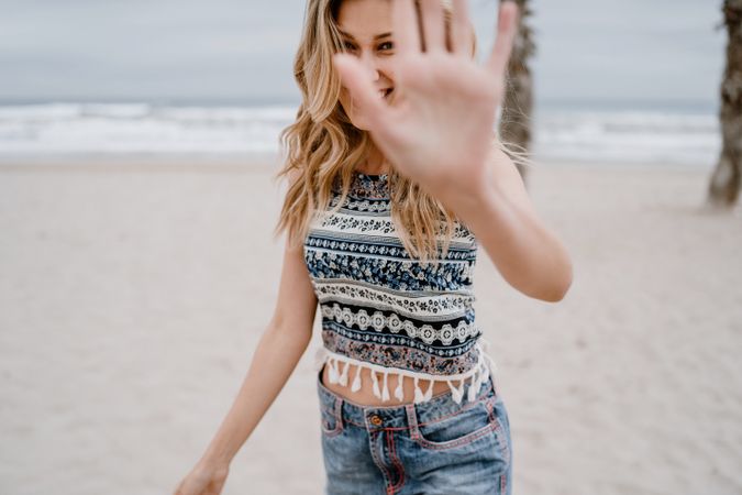 Happy female posing on sandy beach