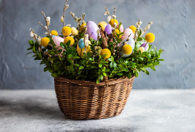 Pastel Easter eggs & flowers in decorative basket
