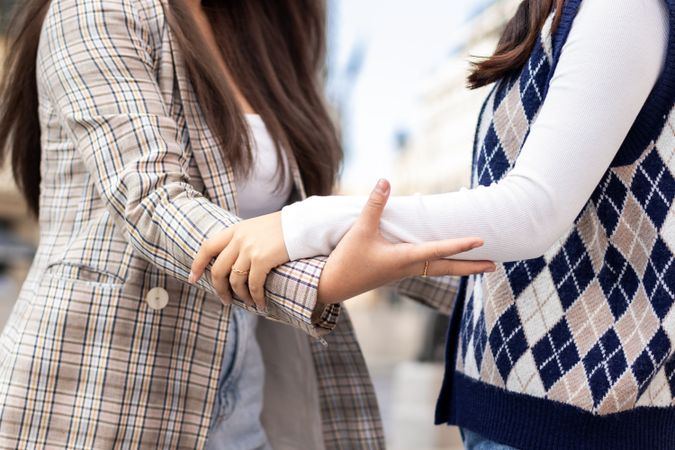 Asian female friends meeting and hugging