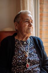 Older woman with personal alarm hanging from the neck