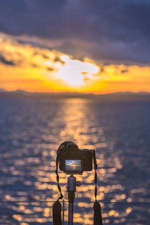 Camera on a tripod capturing the sunset