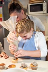 Mother and daughter preparing cookies in kitchen