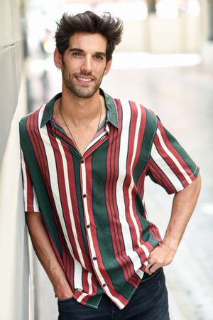 Portrait of happy man with dark hair smiling outside