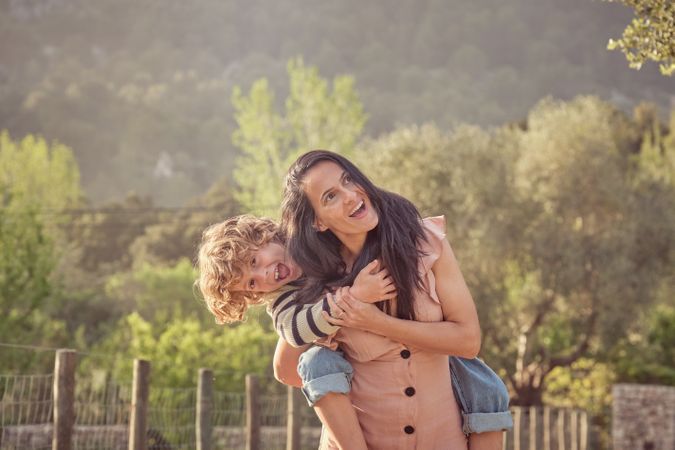 Happy mother with son in countryside