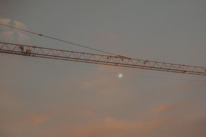Crane under cloudy sunset sky