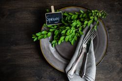 Spring table setting with fresh branch on grey plate