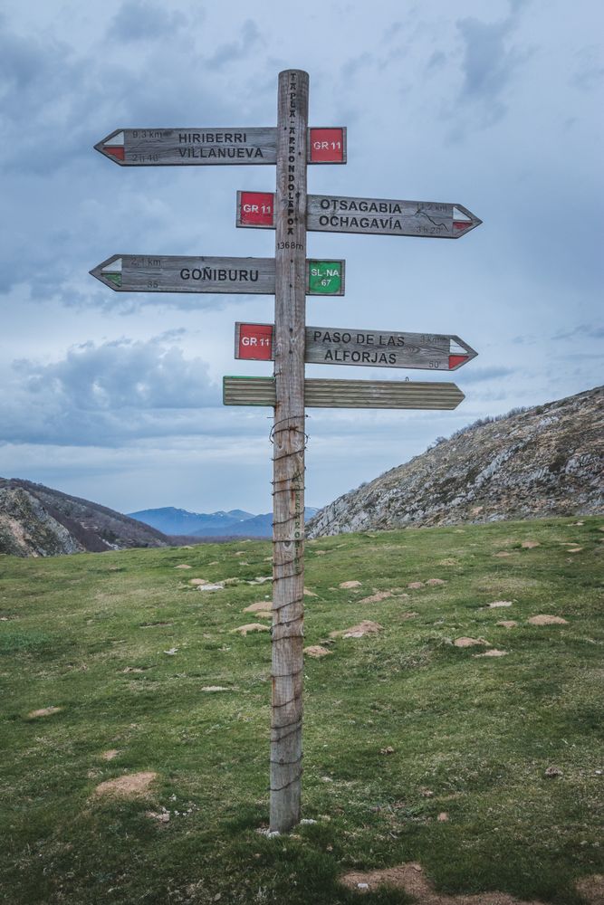 Old guidepost in hilly terrain