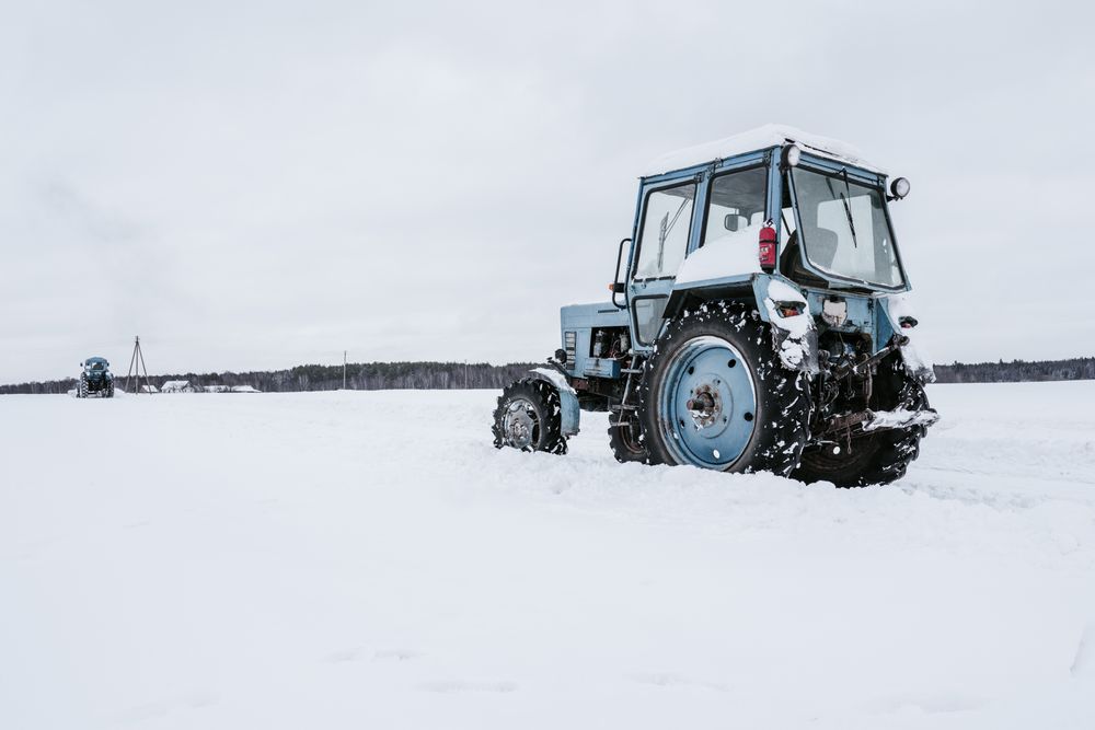 Tractors cleaning snow from field