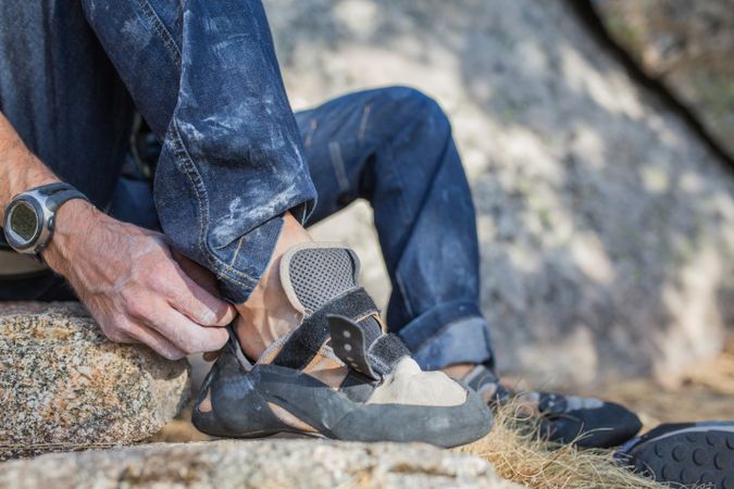 A rock climber is preparing to start climbing