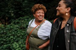 Two women talking while walking outside