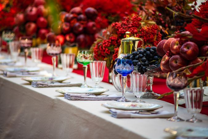 Elegant formal dinner table with glass ware and bowls of fruit