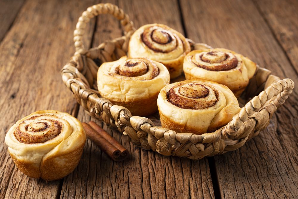 Cinnamon rolls on wooden background.