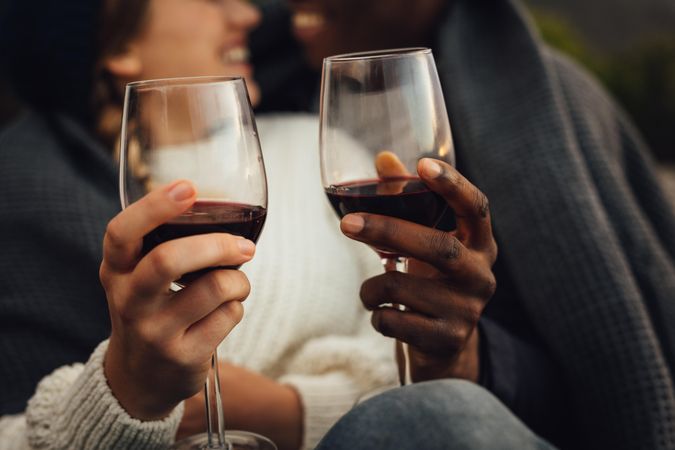 Young man and woman toasting wine glasses