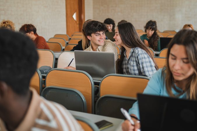 Cheerful teen couple during lesson