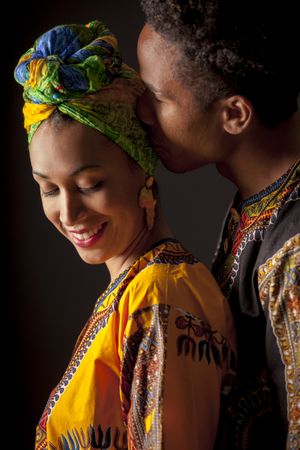 Couple of young Black people standing embracing