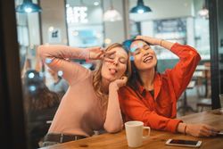 Multiethnic friends talking in cafe