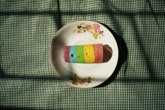 Top view of multicolored cake on plate resting on table