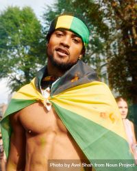 London, England, United Kingdom - August 27, 2022: Man dropped in Jamaican flag at street festival 5wQ7vb