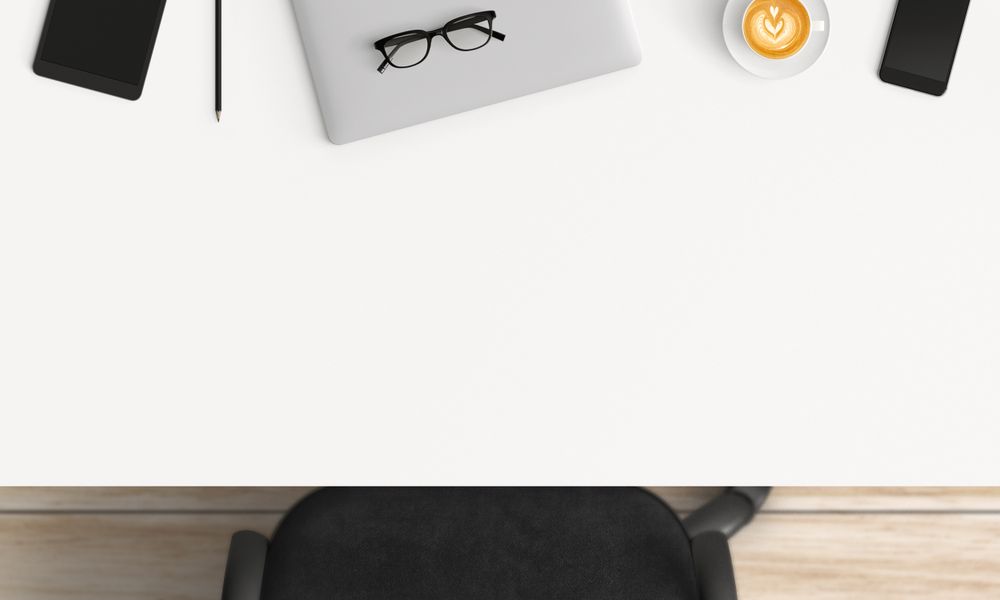 Modern workplace with laptop, coffee cup and smartphone or tablet copy space on table background. Top view. Flat lay style.
