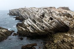 Rocky formations in the island of Baleal on the Atlantic coast in a foggy day. Peniche, Portugal