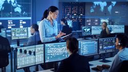 Woman Uses Tablet in High-tech Operations Room.