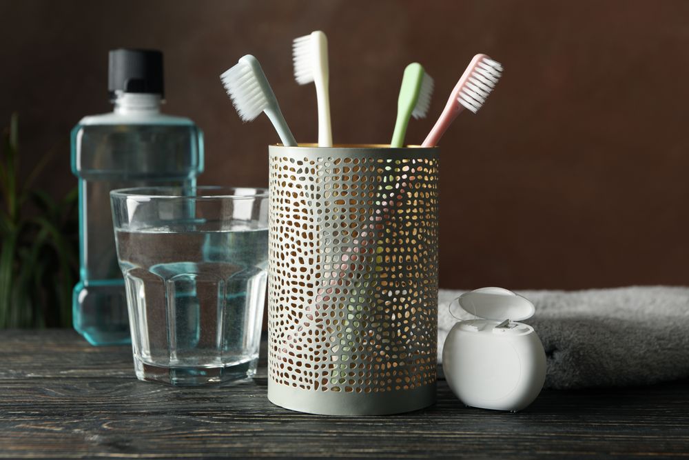 Tools for dental care on brown background, close up
