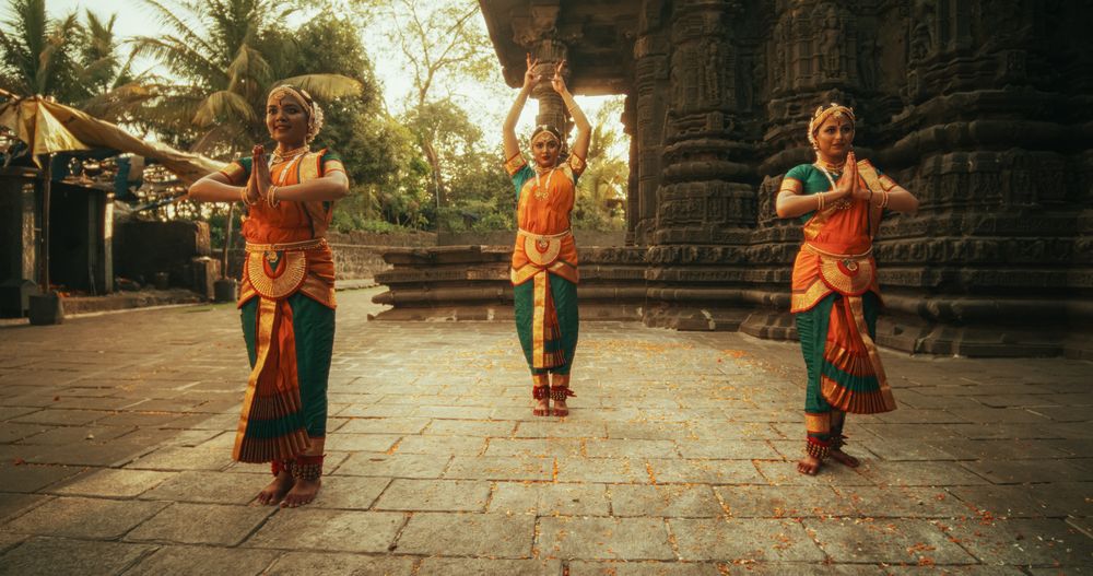Portrait of Three Expressive Young Indian Dancers Performing Folk Dance Choreography in an Ancient Temple.