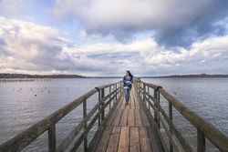 Smiling woman walking on a bridge