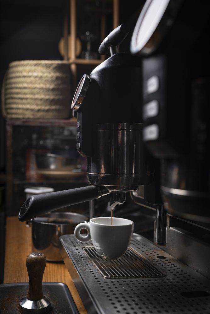 Barista making coffee using a coffee maker