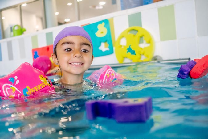 girl with water wings in swimming pool