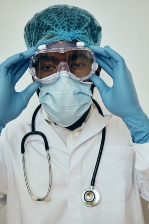 Close up portrait of Black male doctor dressed in full PPE gear