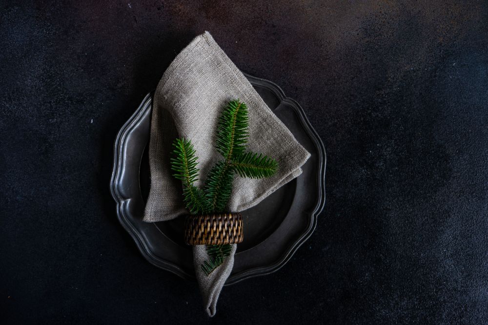 Holiday table setting with fir in napkin
