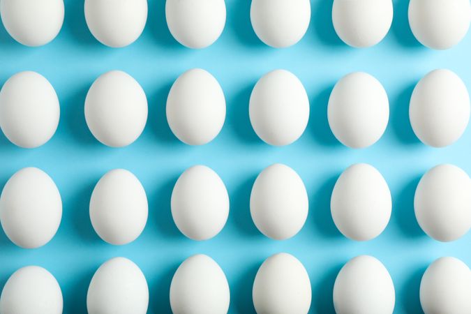 Flat lay composition with chicken eggs on color background, space for text