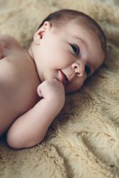 Newborn baby awake on a blanket