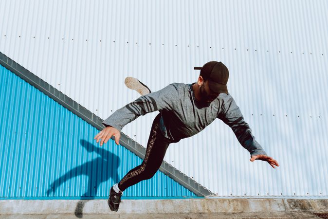 Trendy male flipping on street