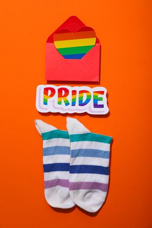 Pride parade concept, symbols on orange background.