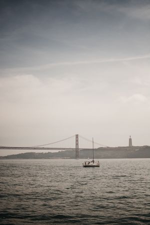 Modern boat in sea near coastal city