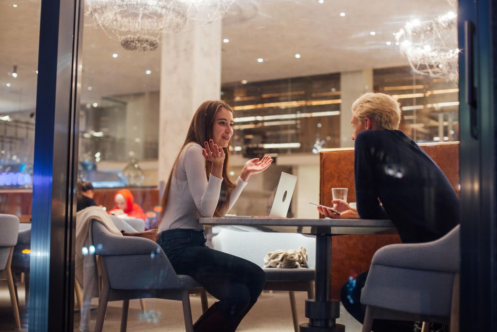 Man and woman discussing work plans in a restaurant